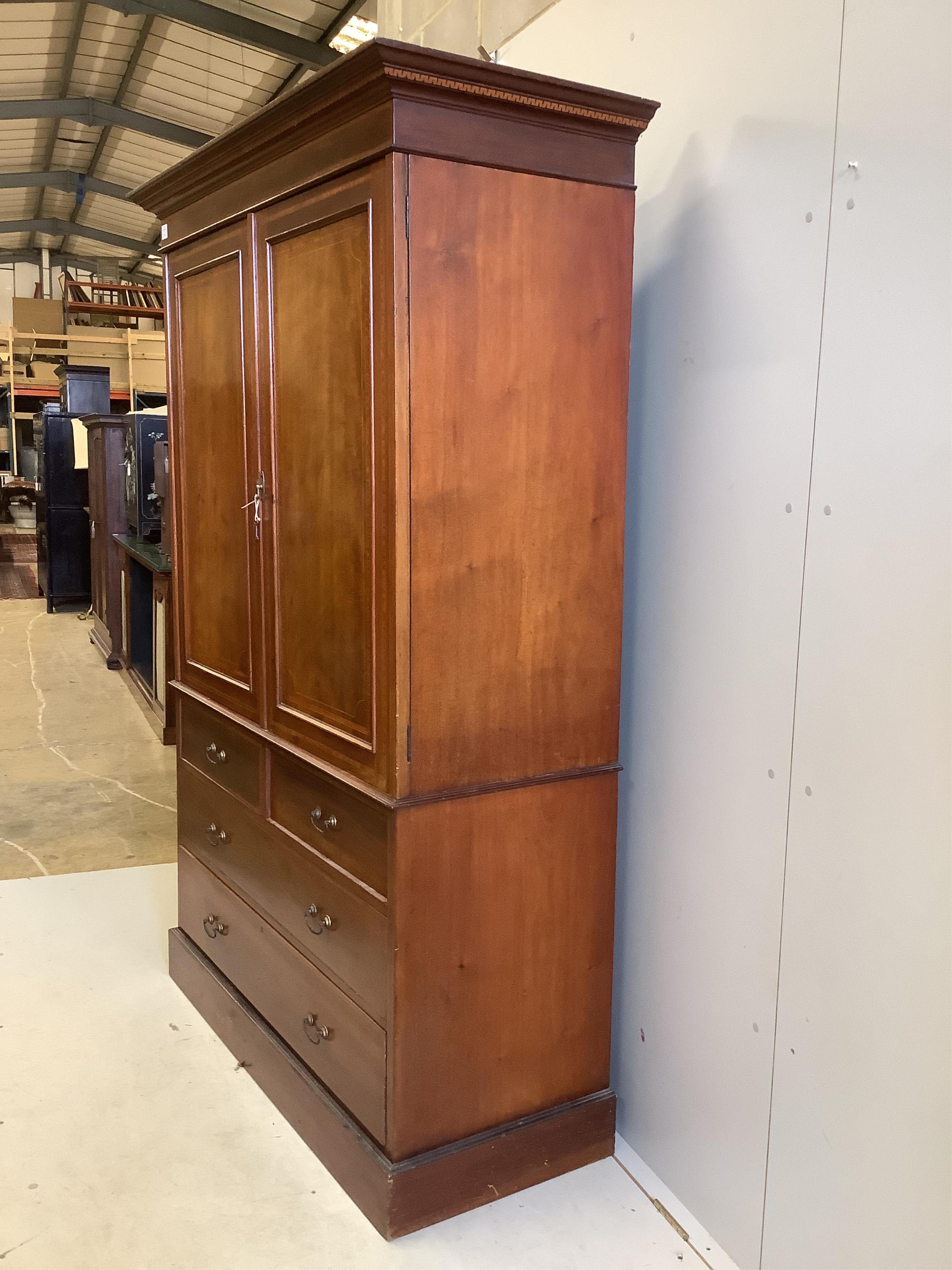 An Edwardian satinwood banded mahogany linen press, width 134cm, depth 56cm, height 200cm. Condition - fair